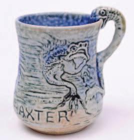 432 433 432 A Martin Brothers salt glazed stoneware small mug of mildly waisted cylindrical form, the handle formed as a grotesque beast, the pale green and blue speckled body sgraffito decorated