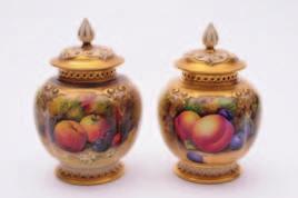 150-200 447 A Royal Worcester porcelain pot pourri jar and pierced painted by Kitty Blake the oviform body set on three feet and with pierced domed cover, the body painted with fruiting and flowering