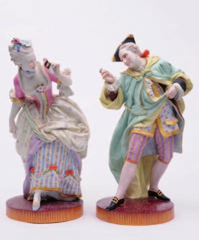 104 455 A pair of large Villeroy and Boch biscuit figures of a dancing gallant and companion, wearing 18th century costume and decorated predominantly in turquoise, yellow and
