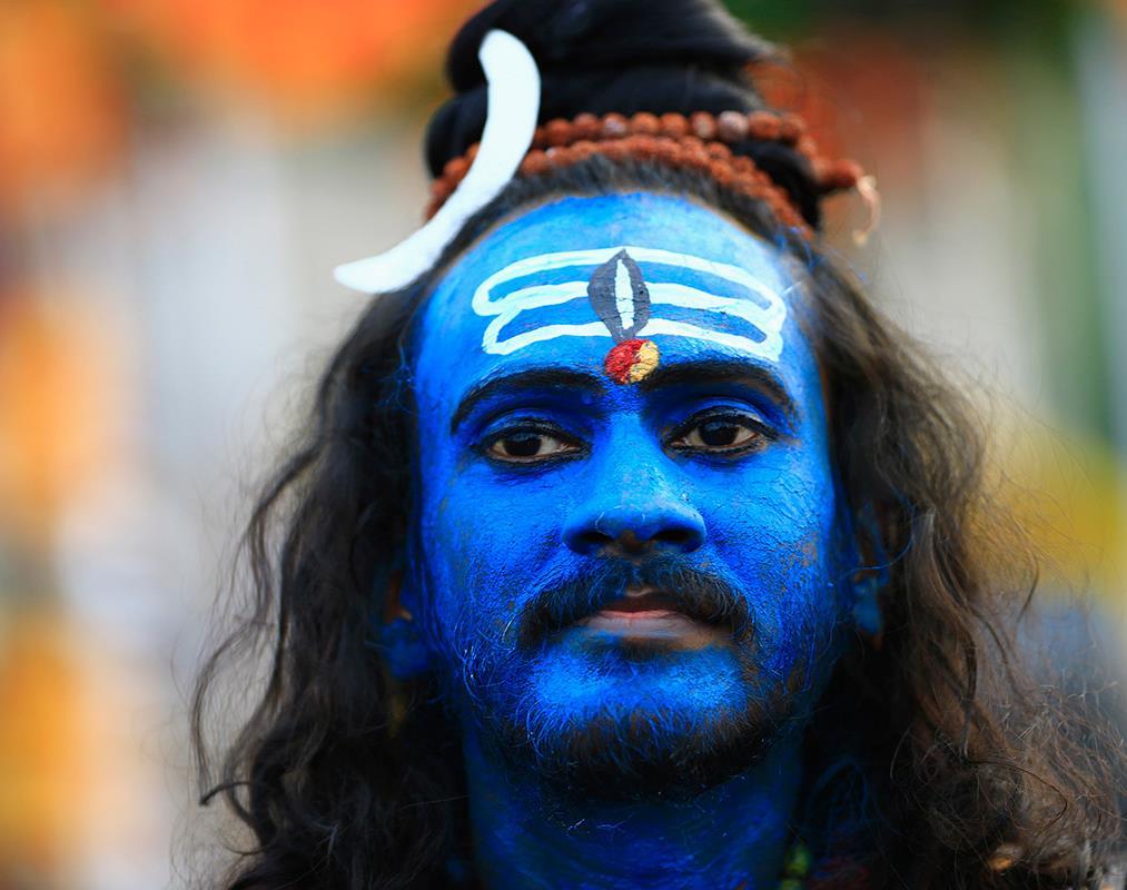 A Hindu devotee, his face painted