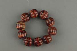 each bead divided into sectioned lobes, the stone of red striations. D: 7 cm, 184.