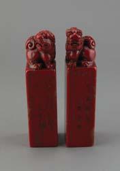 Page: 14 129 Pair of Chinese Chicken Bloodstone Lion Seals Pair of Chinese chicken bloodstone seals, the top surmounted with Fu lions,