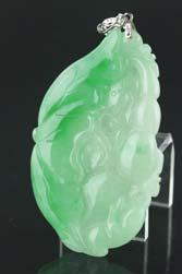 Page: 15 139 Chinese Green Jadeite Carved Lotus Chinese jadeite carved pendant with bail; featuring lotus root on lotus leave; of mixed green and white