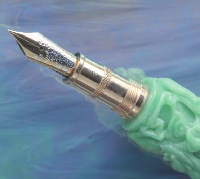 The Loiminchay Nine Dragons and its black lacquer pen rest. The pen sells for $250,000. jade carvers get the jade in their hands, it takes about two months for each pen, Chu details.