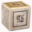 Hidden below a 3 base within the design, a small cavity is created. A containment of cremated remains or a  4.