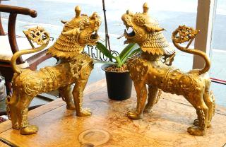 $150 - $300 413 Pair of Oriental style brass Foo dogs.