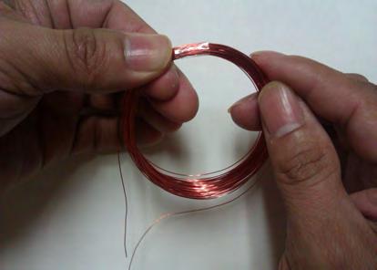 Take a small pieces of transparent tape or masking tape and wrap them on the coil to