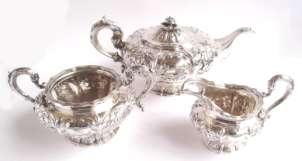 135 139 136 William IV Irish silver three piece tea service of lobed circular form, profusely embossed and decorated with flowers, scrolls and foliage, with crests on raised circular bases,