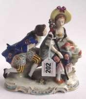 100-200 202 Richly decorated Chelsea Porcelain group of a Gentleman in 18th century costume