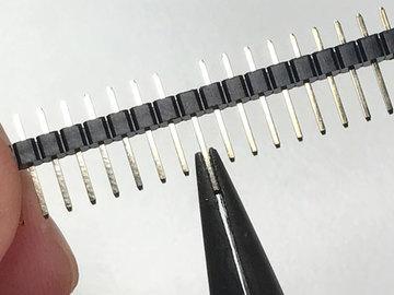 An easy way to do this is to simply pull the pin from the header strip before soldering. Locate the tenth pin of one of the header strips by counting pins inward from one side.
