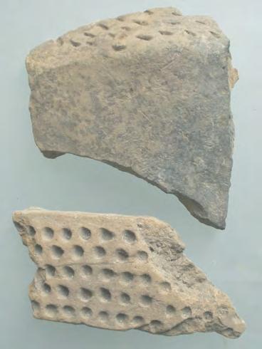 76 CHAPTER IV other surfaces, previously excavated. One of the fragments has red paint over a dotted band (fig. IV.26.