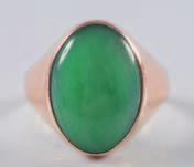 309 An oval green jade mounted single stone ring, the shank stamped 18K.