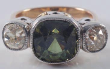 1200-1500 313 An emerald and diamond mounted ring with central emerald-cut emerald, clawset between
