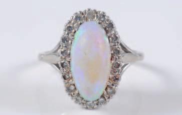 316 An opal and diamond mounted oval cluster ring with central oval opal