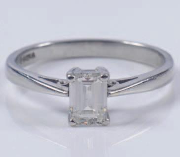500-700 316 317 A platinum and emerald-cut diamond single-stone ring the