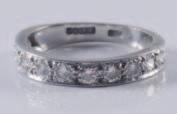 325 329 335 327 325 An 18ct white gold and diamond mounted elevenstone half-eternity ring, paveset with circular brilliant-cut diamonds estimated to weigh a