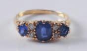 400-500 327 An 18ct gold, sapphire and diamond seven-stone ring with three graduated oval sapphires separated by pairs of old brilliant-cut diamonds.