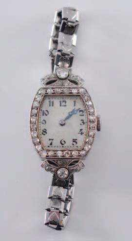 270 271 270 A lady s platinum and diamond mounted cocktail wristwatch the cushionshaped dial