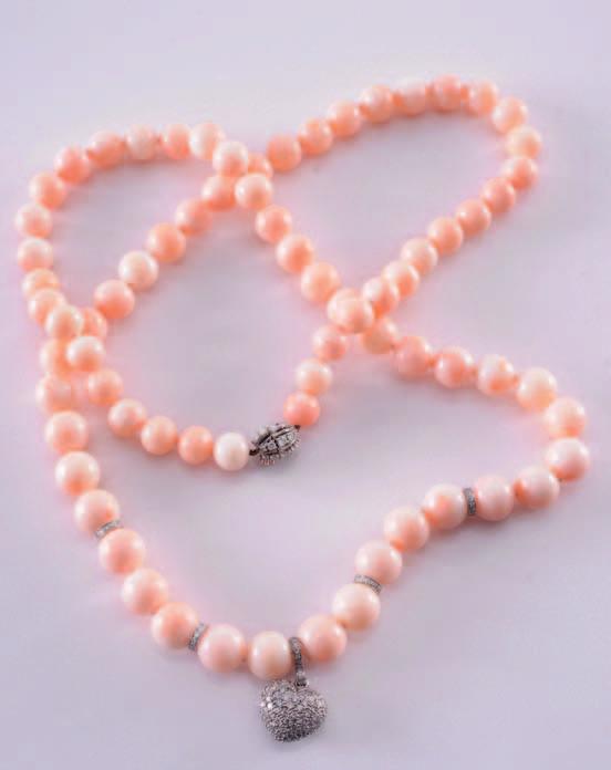 290 A pink coral and diamond necklace composed of pink coral beads, graduated from 9.2mm to 11.