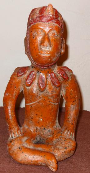 Seated Chieftain This is an earthenware tomb figure from the Colima area of West Mexico. He wears a headdress with an animal horn.