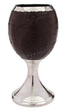 * 120-180 168 A George III Scottish silver mounted coconut cup, maker Alexander Spence, Edinburgh, 1790 the coconut shell carved with thistles, palm trees and pineapples on a waisted stem and