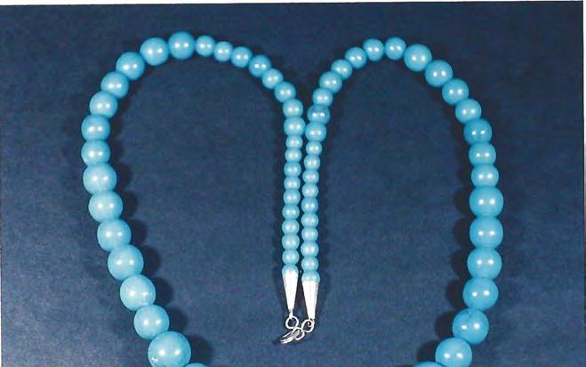 Figure 18. Tl~is imitation turquoise necklace is actl~ally gibbsite; the berrds range from 5.7 to 14.5 mm in diameter. Nepal first began to appear in the 1960s.
