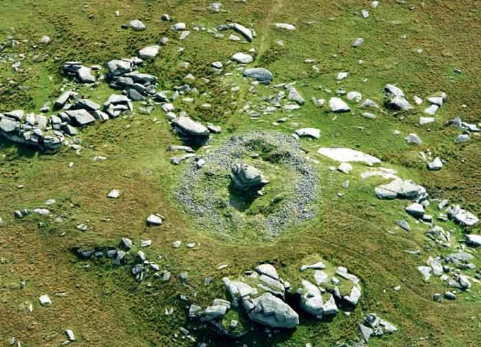 A ring cairn on Showery Tor, St Breward. The summit of Showery tor is marked by an impressive Cheesewring of weathered granite slabs. This has been surrounded by a massive cairn of piled stones.