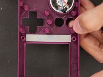The buttons should fit into the cuts on the enclosure.
