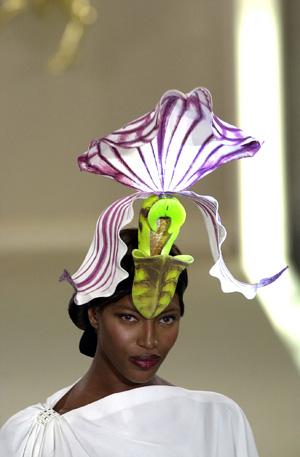 He uses a range of materials such as straw, plastic, feathers, wire, net, lace and fabric to make his three-dimensional hats.