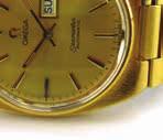 1 gms (2) 100-150 1011 A gold plated Hebdomas patent 8 day open face pocket watch on a yellow metal watch chain suspending a fruit