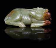 626 A Carved Jade Goose Form Coupe of a mottled russet colored stone, the coupe formed from the body of the goose, the neck craned around towards the back, a sprig of lingzhi in the beak, the