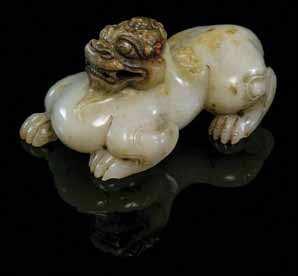 642 A Carved Jade Figure of a Winged Chimera of a pale celadon stone, the beast depicted foursquare with curled wings. Width 2 1/8 inches.