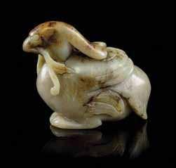 642 644 A Carved Jade Figure of a Horse the a celadon stone, the recumbent animal depicted with its head turned backwards. Height 1 3/8 inches.