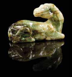 669 674 676 677 669 A Small Jadeite Box and Cover of a pale green stone with natural inclusions, of cylindrical form, the body carved with two shaped reserves, one enclosing a landscape scene, the