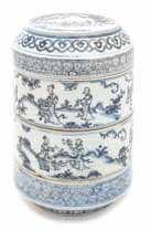 697 698 699 700 701 705 697 A Blue and White Four-Tiered Storage Box of cylindrical form, the cover having a recessed circular top depicting igures on horseback, with a band of ruyi to the canted