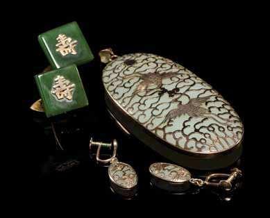Property from the Collection of Jim and Betty Callihan, Chicago, Illinois $200-400 750 A Gold Mounted Jade Pendant and Ear Clips of a pale celadon jade, the oval form