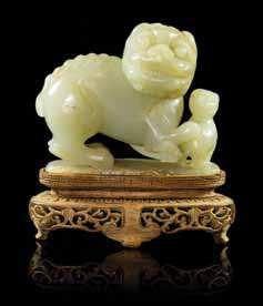 Louis, Missouri $800-1,200 822* A Carved Jade Plaque of rectangular form, with pierce carved decoration of a sinuous ive-claw dragon chasing the laming pearl of wisdom, surrounded by peaches and