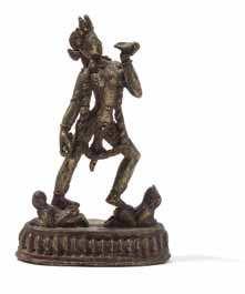 952 A Gilt Bronze Figure of a Vajrayogini the bodhisattva depicted standing on two humanform igures with her feet apart, her left hand raised to the chest holding a cup and her right hand bearing a