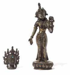 953 A Gilt Bronze Figure of a Bodhisattva the standing igure with eight arms holding attributes or in various mudras, wearing an incised robe, beaded necklaces and a peaked diadem with turquoise and