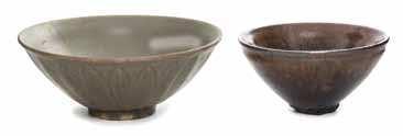 $1,200-1,800 62* Two Glazed Bowls the irst having a celadon glazed with the exterior incised overlapping leaves decoration, the second covered overall in black and brown glaze with a lared mouth rim