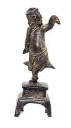 $2,000-4,000 249* A Bronze Figure of Liu Hai 17TH CENTURY the igure depicted with a circular cap and large hoop earrings, his robes having long, draped sleeves and secured with a cord belt, in a