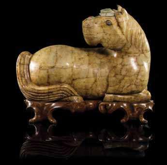 401 A Carved Soapstone Figure of a Horse depicted kneeling, with its head craned around towards its tail, having hardstone inlaid decoration, with apocryphal Da Ming mark incised to the underside,