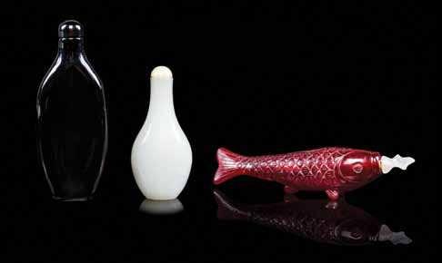Property from a Private Collection, Michigan $300-400 477 A Group of Three Snuf Bottles the irst a glass example shaped like a ish, the second of red amber, the third of a milky white glass