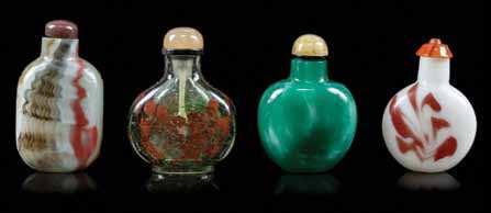478 A Group of Four Glass Snuf Bottles the irst of a rich, opaque green, the second transparent with red splash decoration, the third and fourth decorated to simulate hardstones.