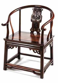561 562 561 A Carved Hardwood Horseshoe Back Chair having a pierced vertical splat with relief carved
