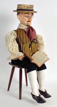 446 A GOOD 19TH CENTURY AUTOMATON FIGURE OF AN ELDERLY MALE modelled in Victorian style clothing, seated upon a stool, with revolving head and moving arms,