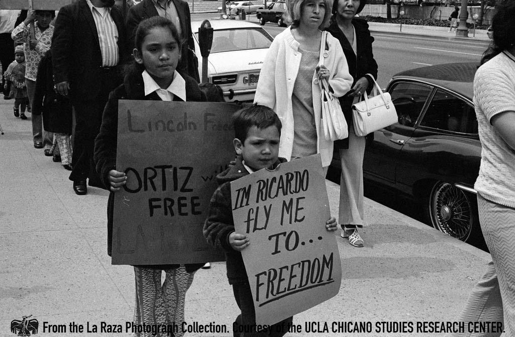 Children carrying signs in support of Ricardo Chavez Ortiz in downtown Los Angeles