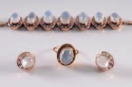 245. A moonstone mounted bracelet with graduated, oval links, matching ring