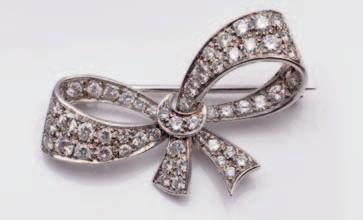 251 249 249. An 18ct white gold and diamond mounted ribbon brooch set with circular brilliant-cut diamonds. 400-600.