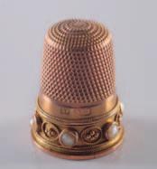 A late 19th century 9ct gold and seed pearl thimble. 150-200. 278 277.